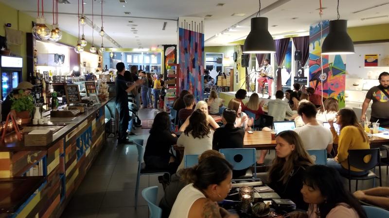 photo of a coffee shop packed with patrons sitting at tables