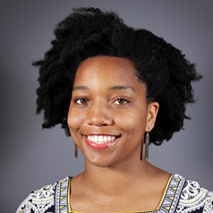 headshot of writer Destenie Nock posing in front of a gray photo background