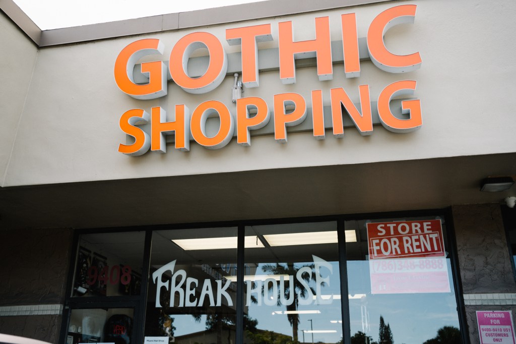 photo of an orange sign above a store reading "Gothic Shopping"