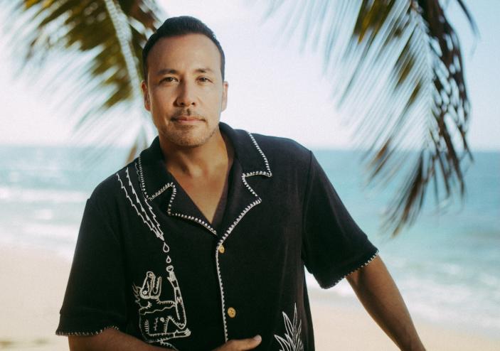 photo of Howie D of the Backstreet Boys posing with the beach and palms in the background