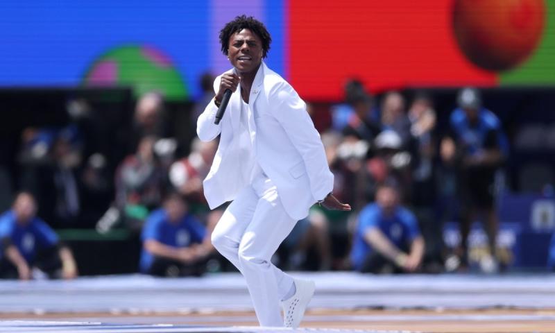 A photo of a young man performing on stage.