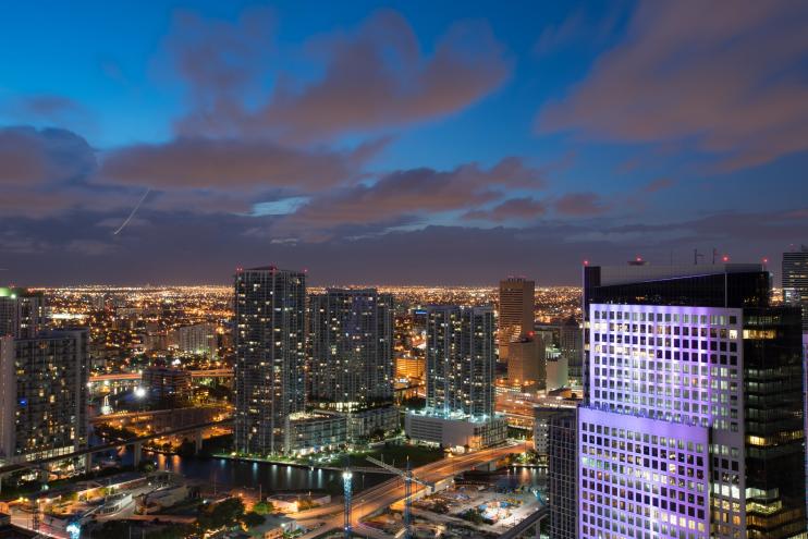 towers dot the skyline and light the night sky