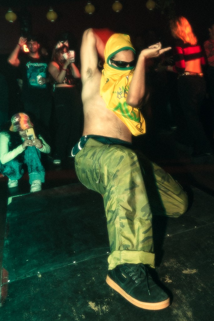A shirtless man dancing in Miami wearing a Brazilian jersey.