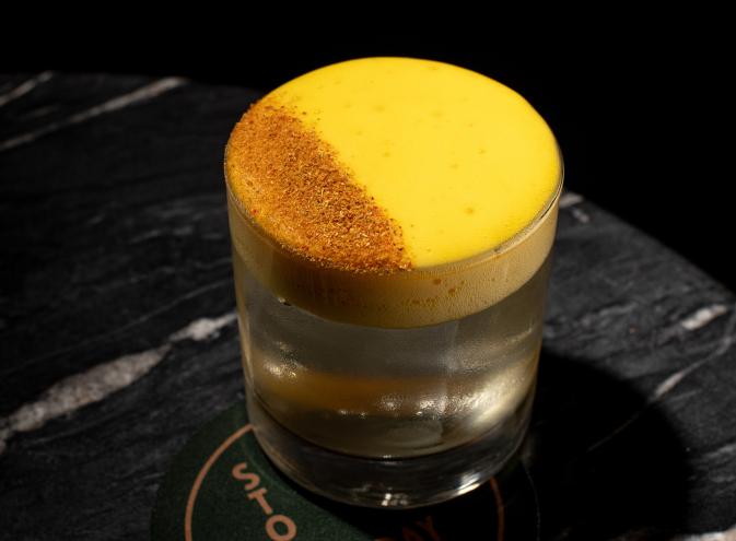 yellow and orange cocktail with black background