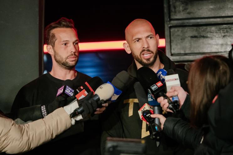 photo of the Tate brothers being interviewed in front of news mics