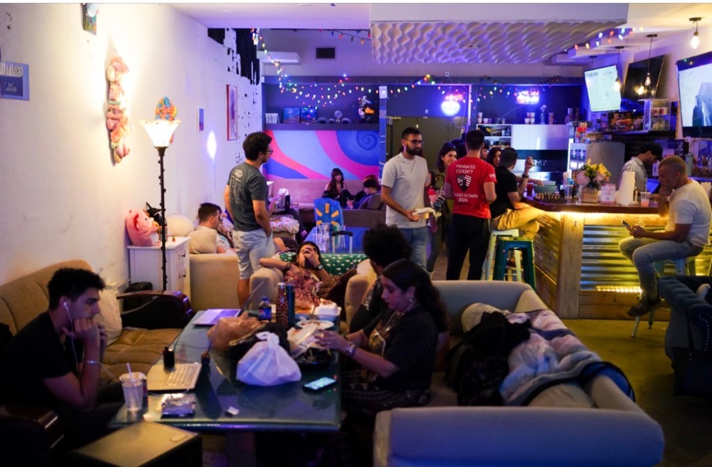 A small venue full of people in Miami. 