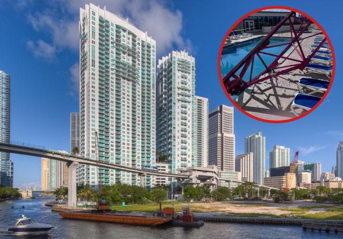 a city skyline with a river in the foreground and a cutout of a crane collapse collaged in the top corner