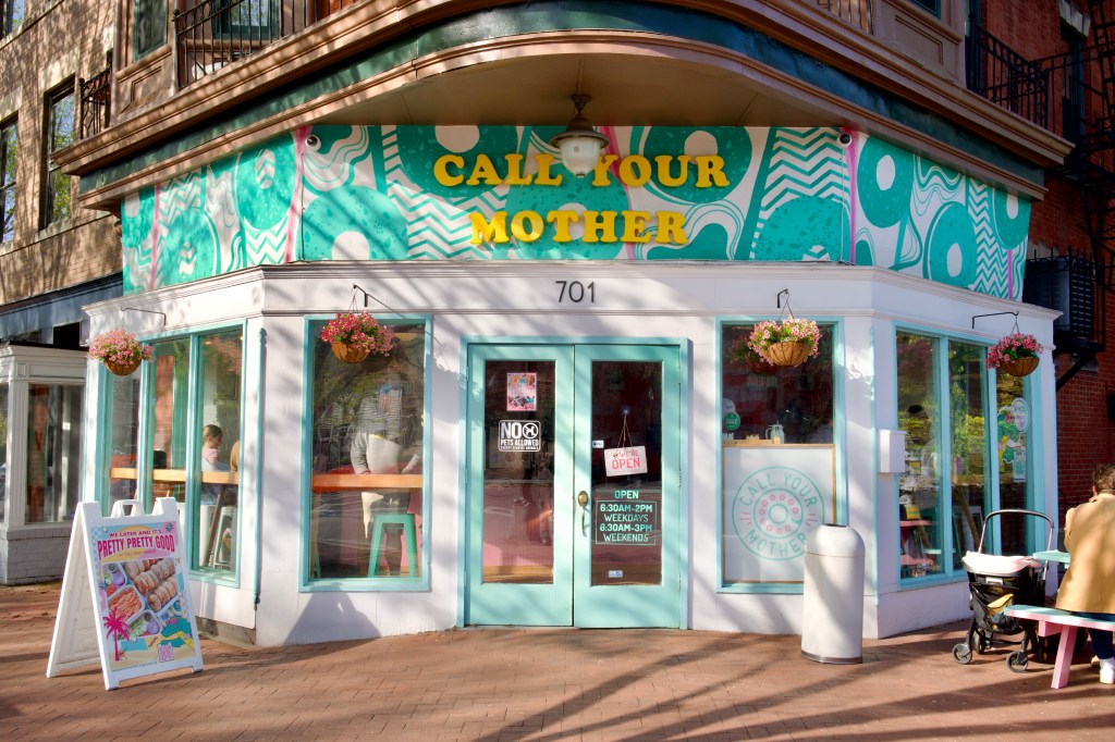 a teal and white storefronts that reads "CALL YOUR MOTHER"