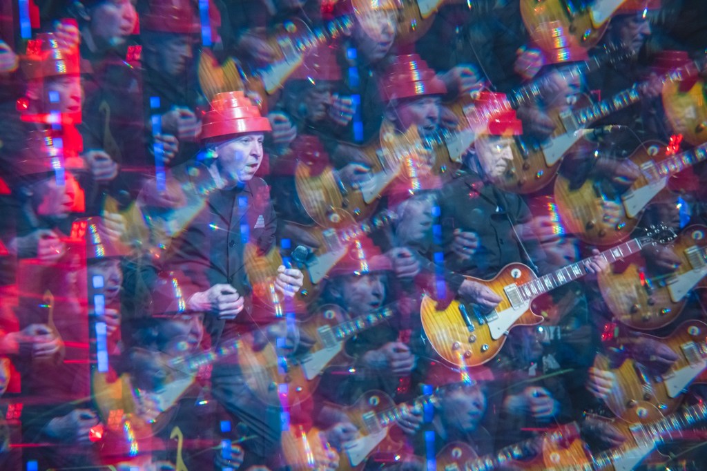 Photo of Devo with an effect that shows their faces multiple times in the frame
