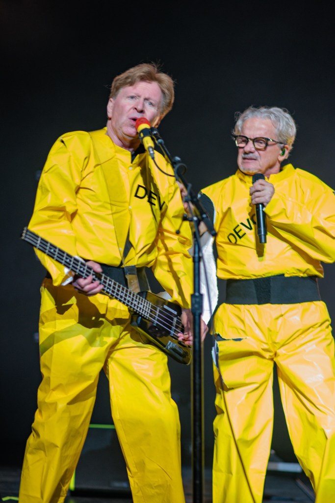 Photo of two members of Devo on stage in Miami