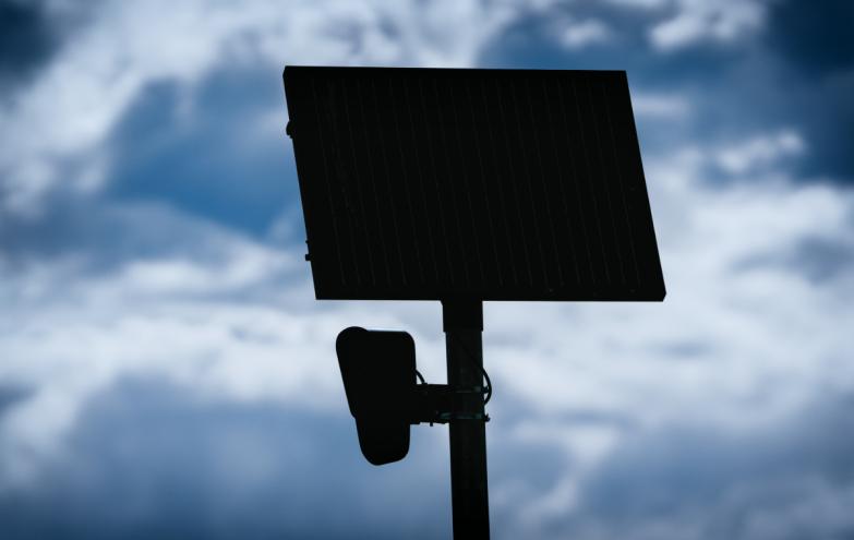 A photo of a silhouette of a Flock camera.