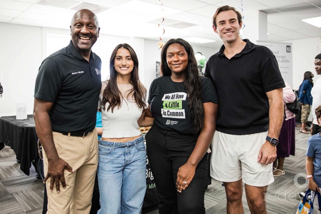photo of four people posing at a back-to-school event