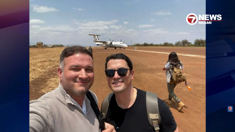 A screenshot from a local news broadcast showing two men posing together.
