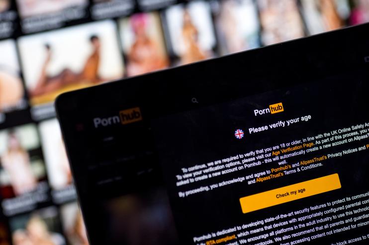 In this photo illustration, the age-verification screen is displayed on the website Pornhub on July 25, 2025 in London, England.