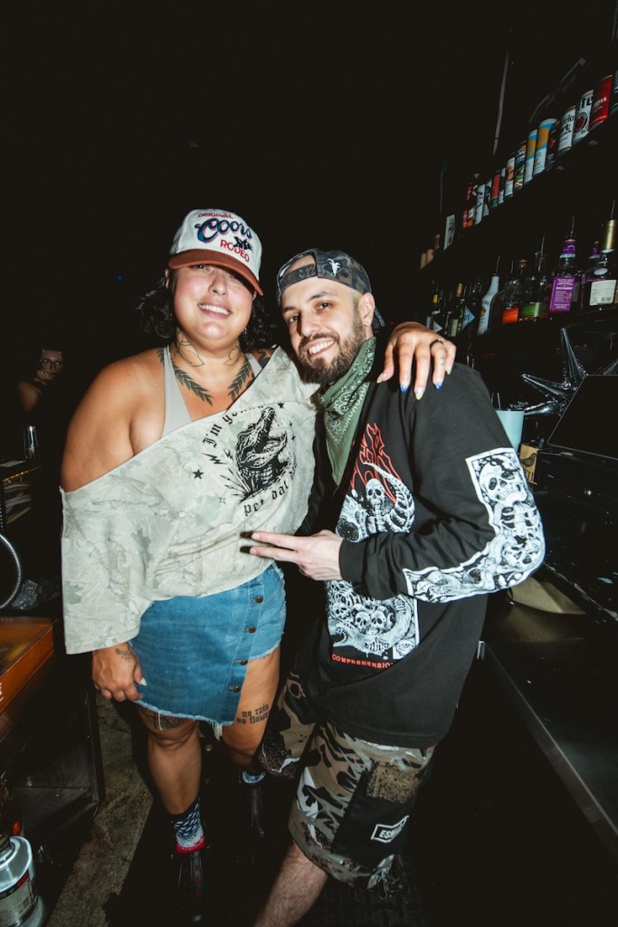 Photo of two people wearing baseball hats posing for the camera