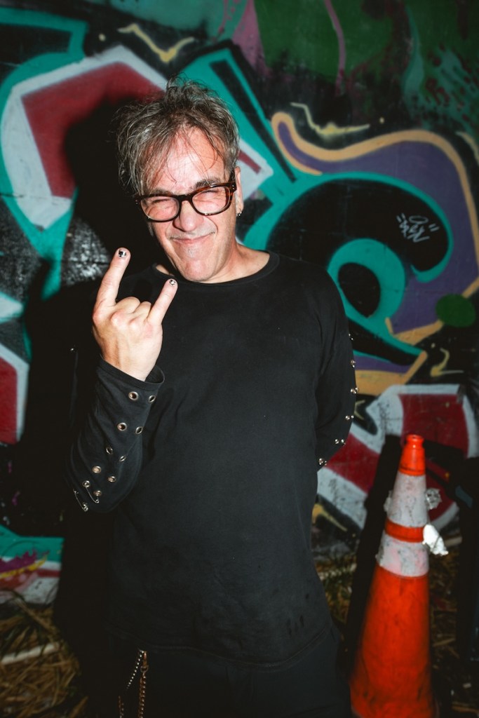 Photo of a man wearing a black shirt posing for the camera