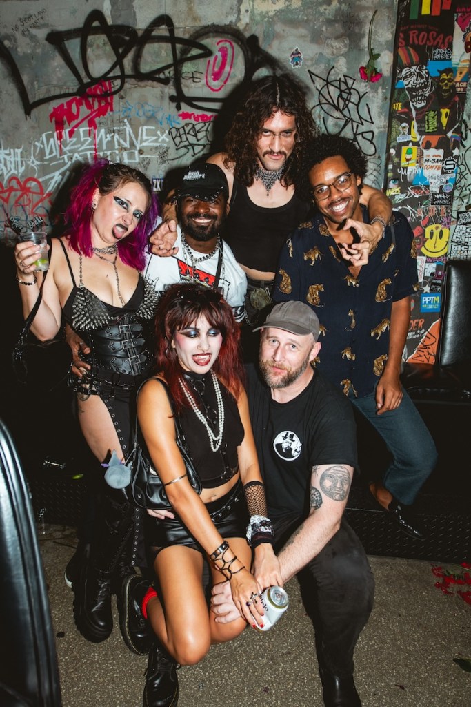 Photo of a group of dix people wearing rock n' roll style clothing
