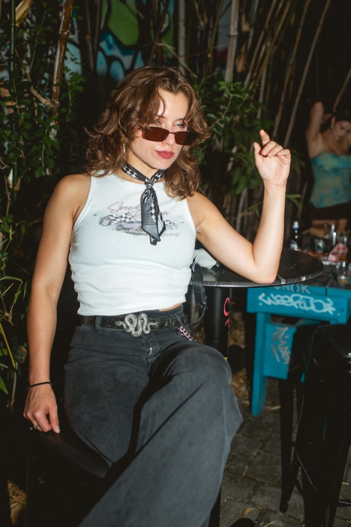 Photo of one woman wearing a shote shirt and sunglasses