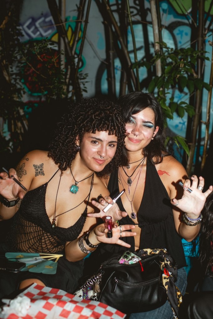 Photo of two women wearing black posing for the camera