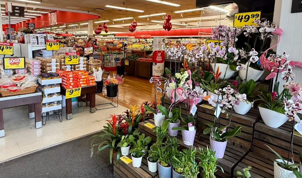 a grocery store with flowers being sold