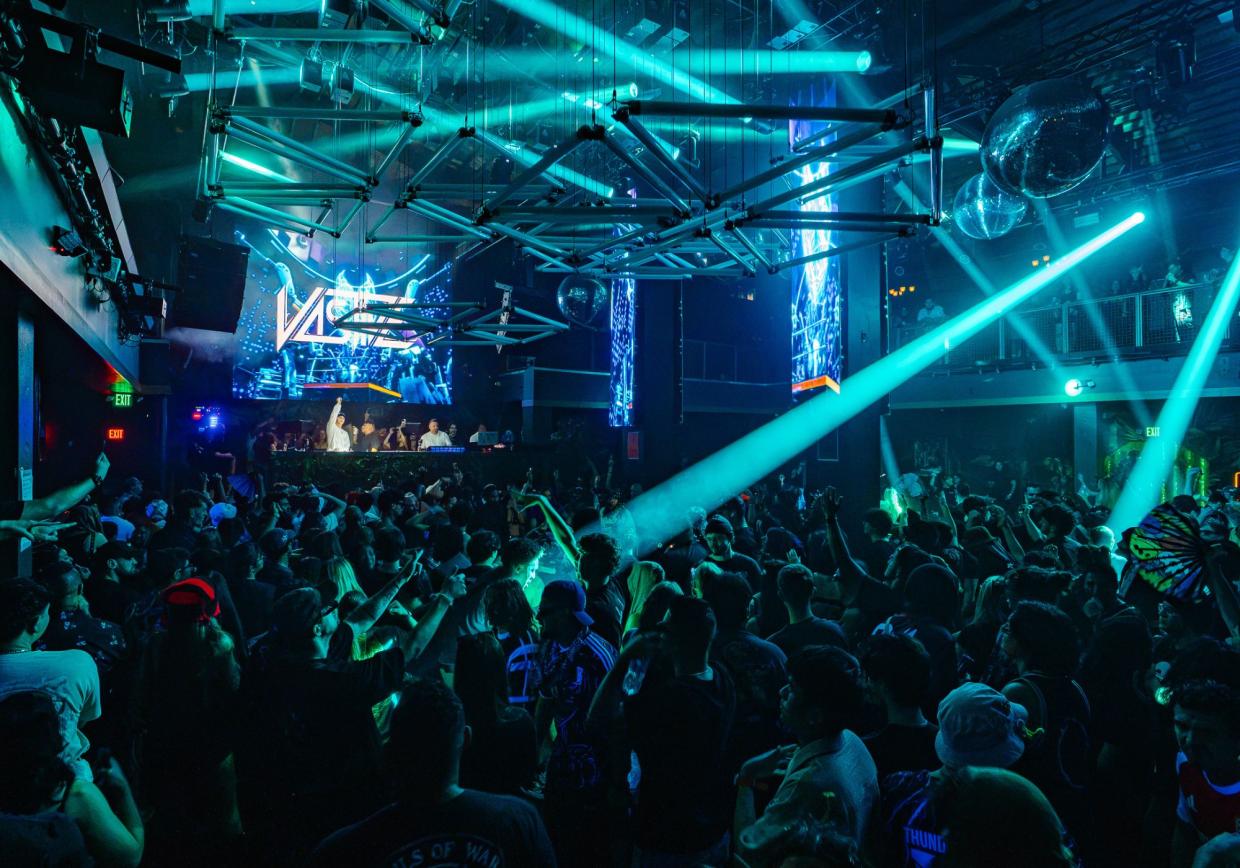 Photo of a nightclub in Miami with a big crowd and blue LED lights.