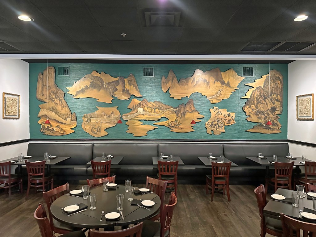 a dining room with artifacts on the walls