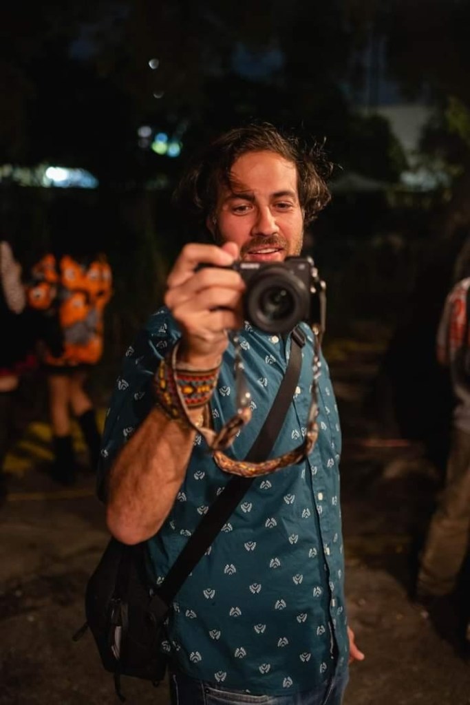 Photo of a man holding a camera taking a photo of himself