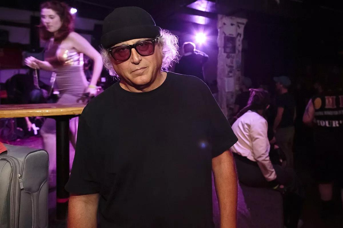Picture of a man wearing glasses and a beanie