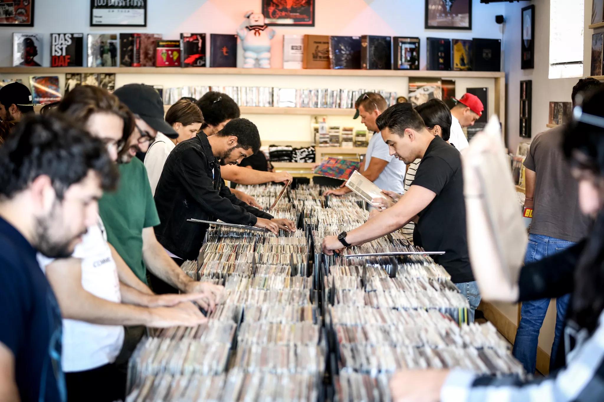 People digging through records at Technique Records in Miami