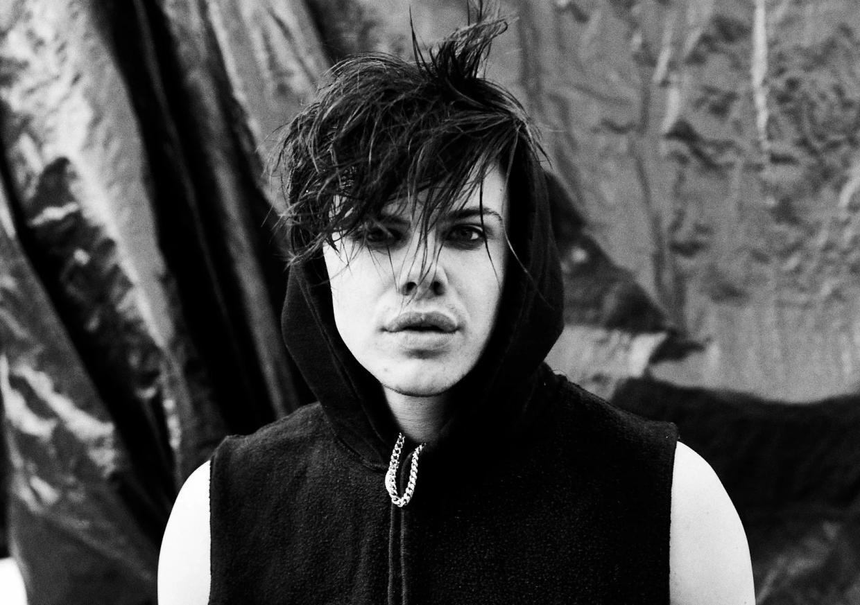black and white picture of a young man looking at the camera.
