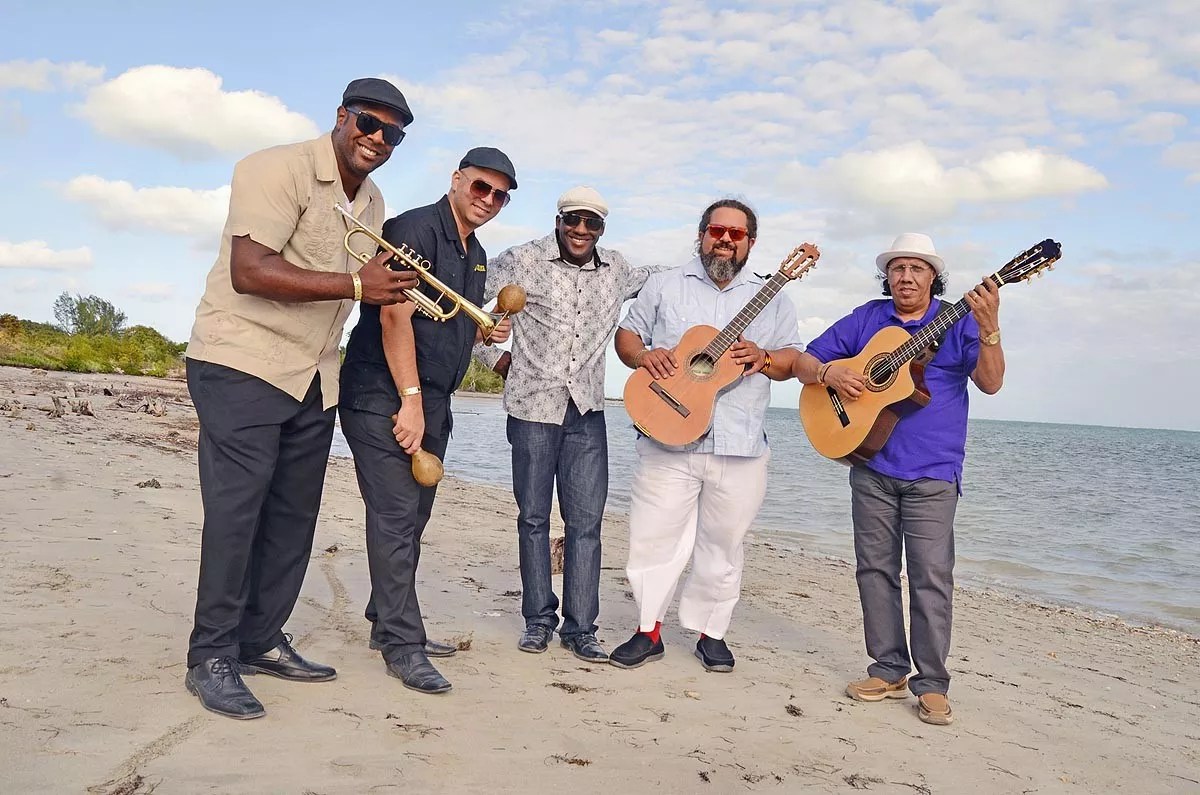 Photo of five Cuban musicians by the beach in Miami
