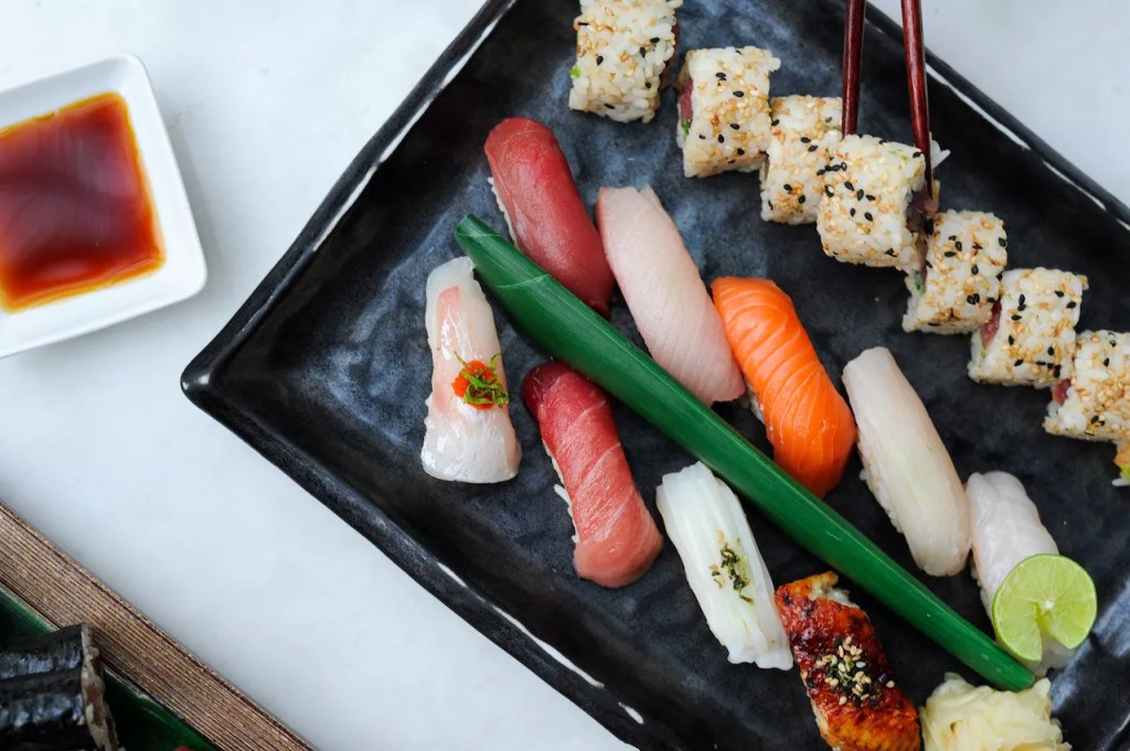 Sushi rolls on a black platter