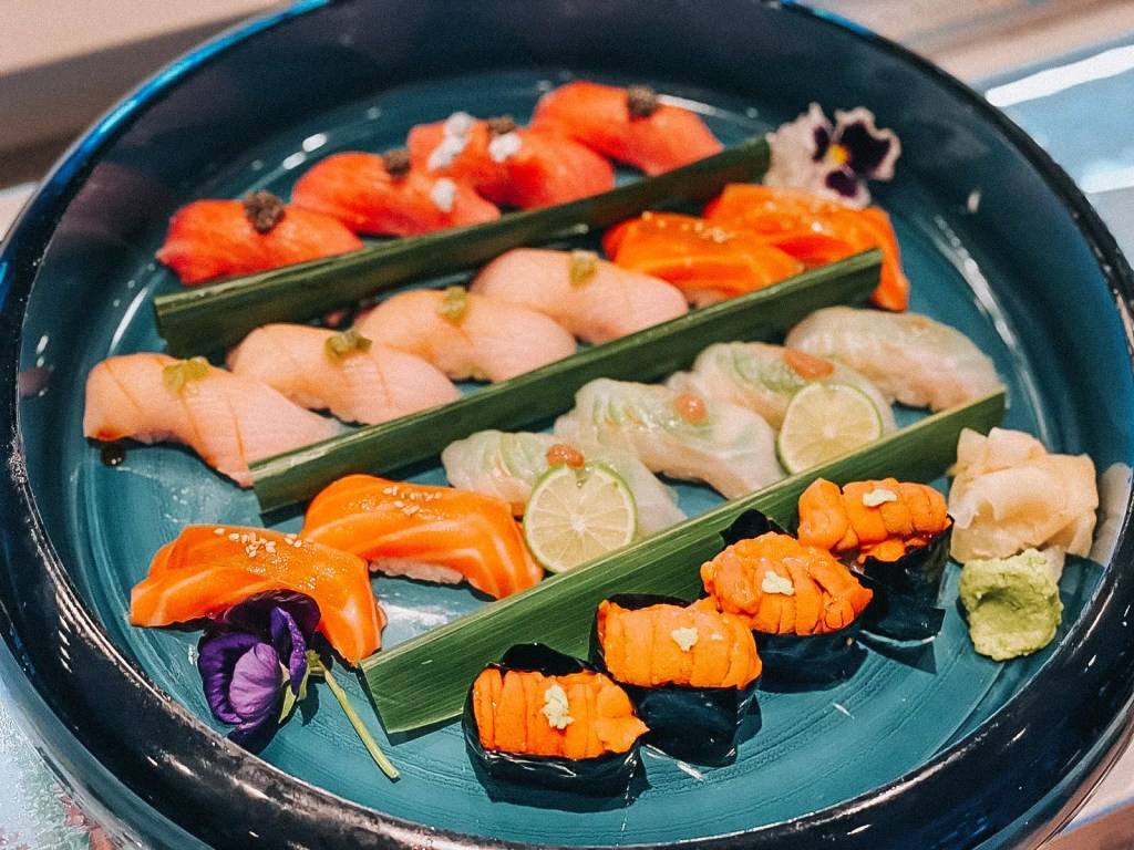 a platter of nigiri and sushi with different colors