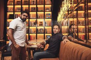 Two men sit in a restaurant