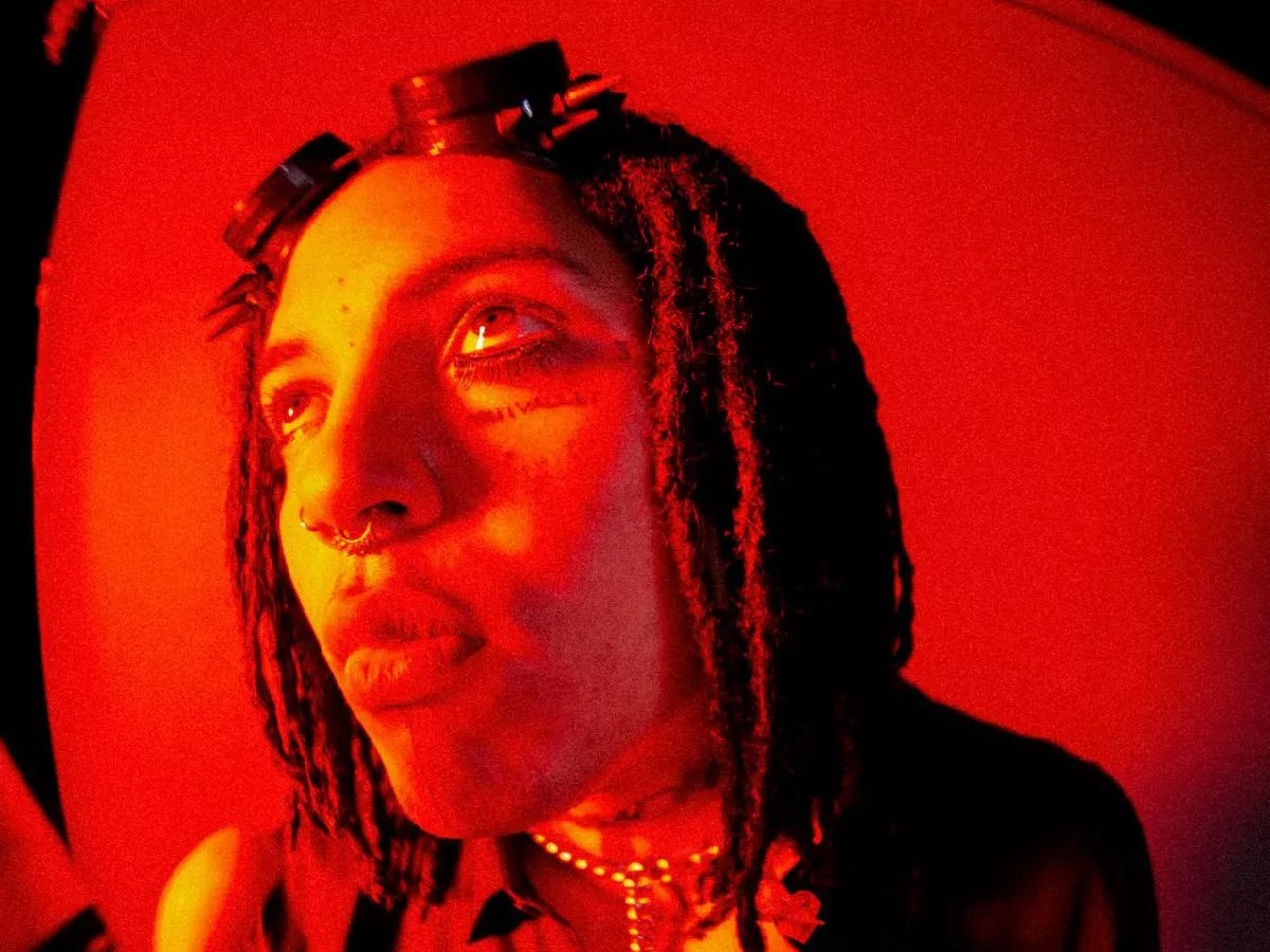 Photo of a man under red lights