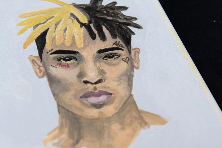 A portrait painted by a fan and left at a makeshift memorial outside the XXXTentacion Funeral & Fan Memorial at BB&T Center in Sunrise, Florida, on June 27, 2018