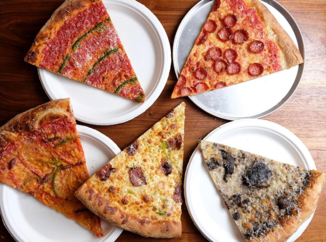 Slices of pizza on paper plates