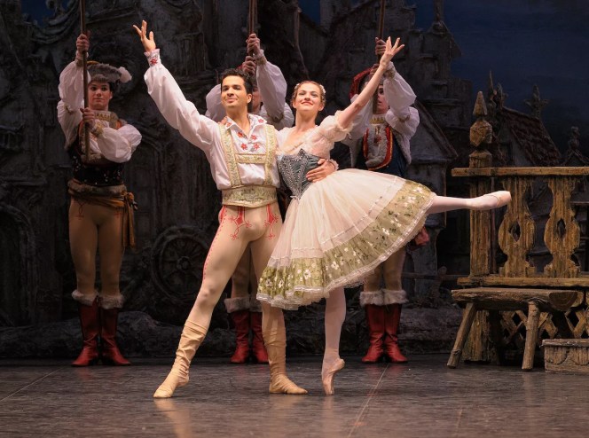 photo of one male and one female ballet dancer posing onstage