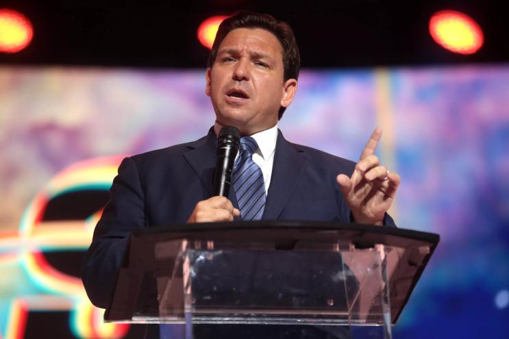 Florida Governor Ron DeSantis speaks at a podium at a Tampa, Florida, convention center