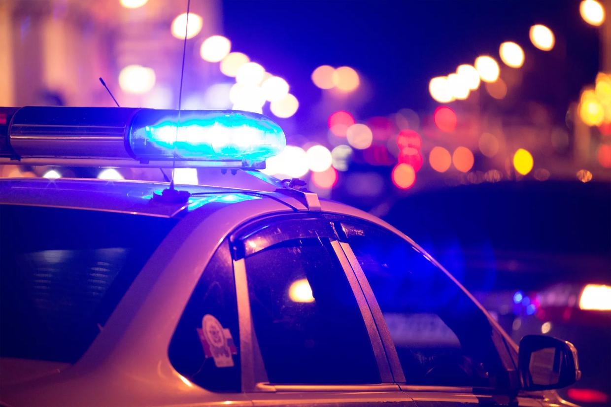 Stock photo of a police car with lights activated