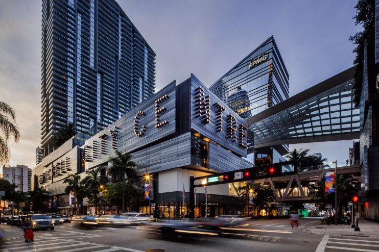 A busy intersection at Brickell City Center, a modern luxury shopping complex paneled with glass