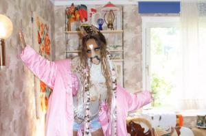 HorsegiirL, a DJ who wears a horse mask, poses in a room