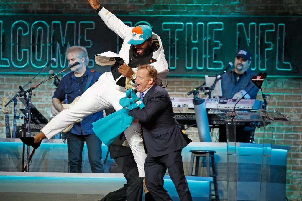 Christian Wilkins jumps next to NFL Commissioner Roger Goodell after he is drafted by the Miami Dolphins during the 2019 NFL Draft in Nashville.