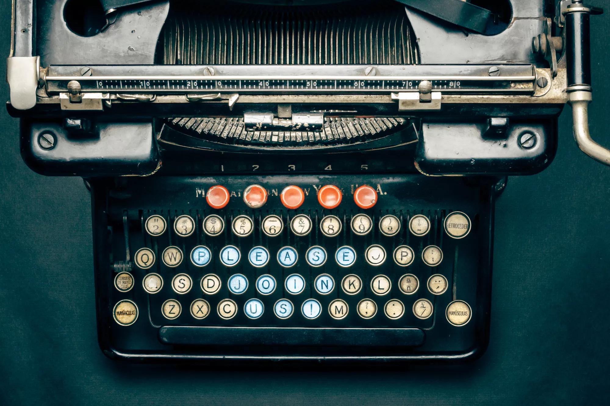 antique typewriter with keys photoshopped to read "PLEASE JOIN US"