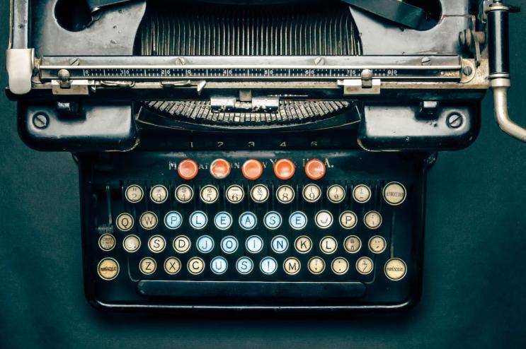 antique typewriter with keys photoshopped to read "PLEASE JOIN US"