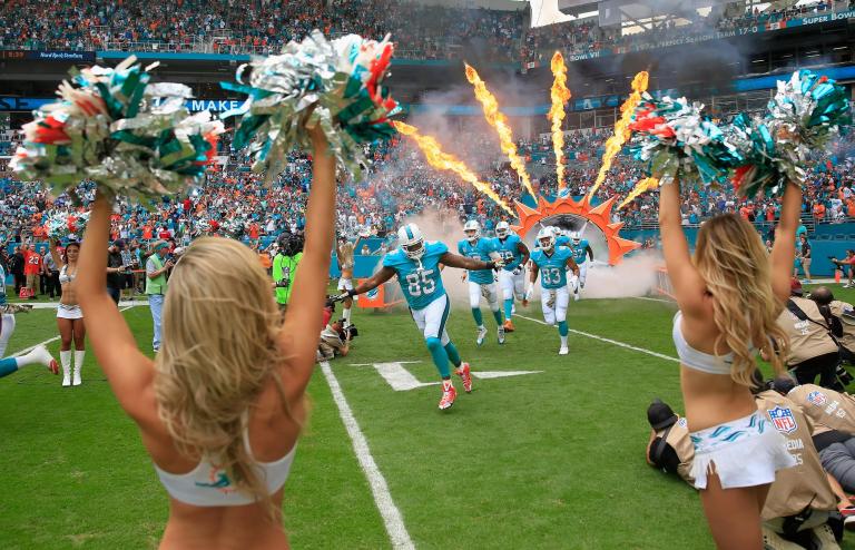 Football players trot onto the field