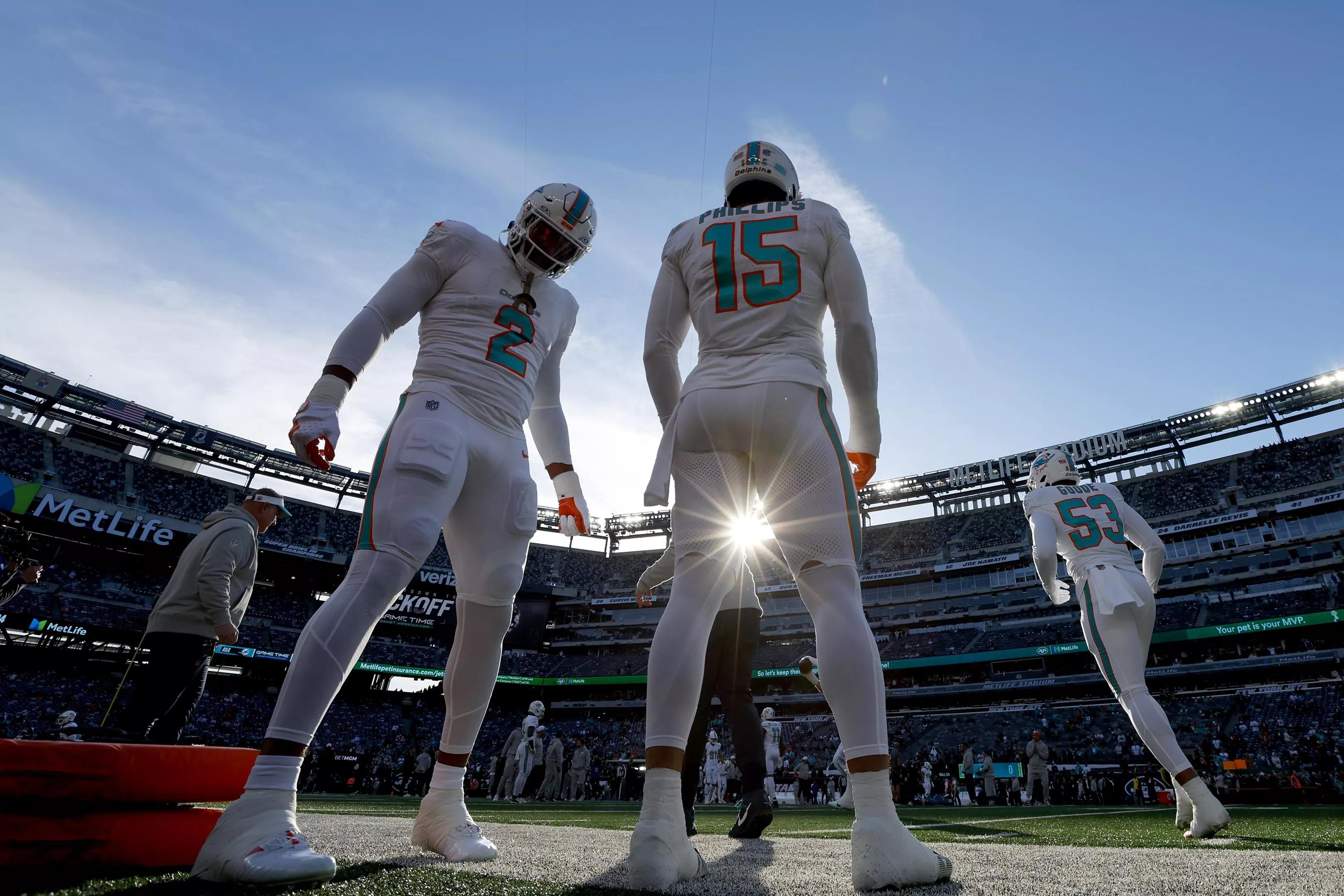 Two football players tower over a camera