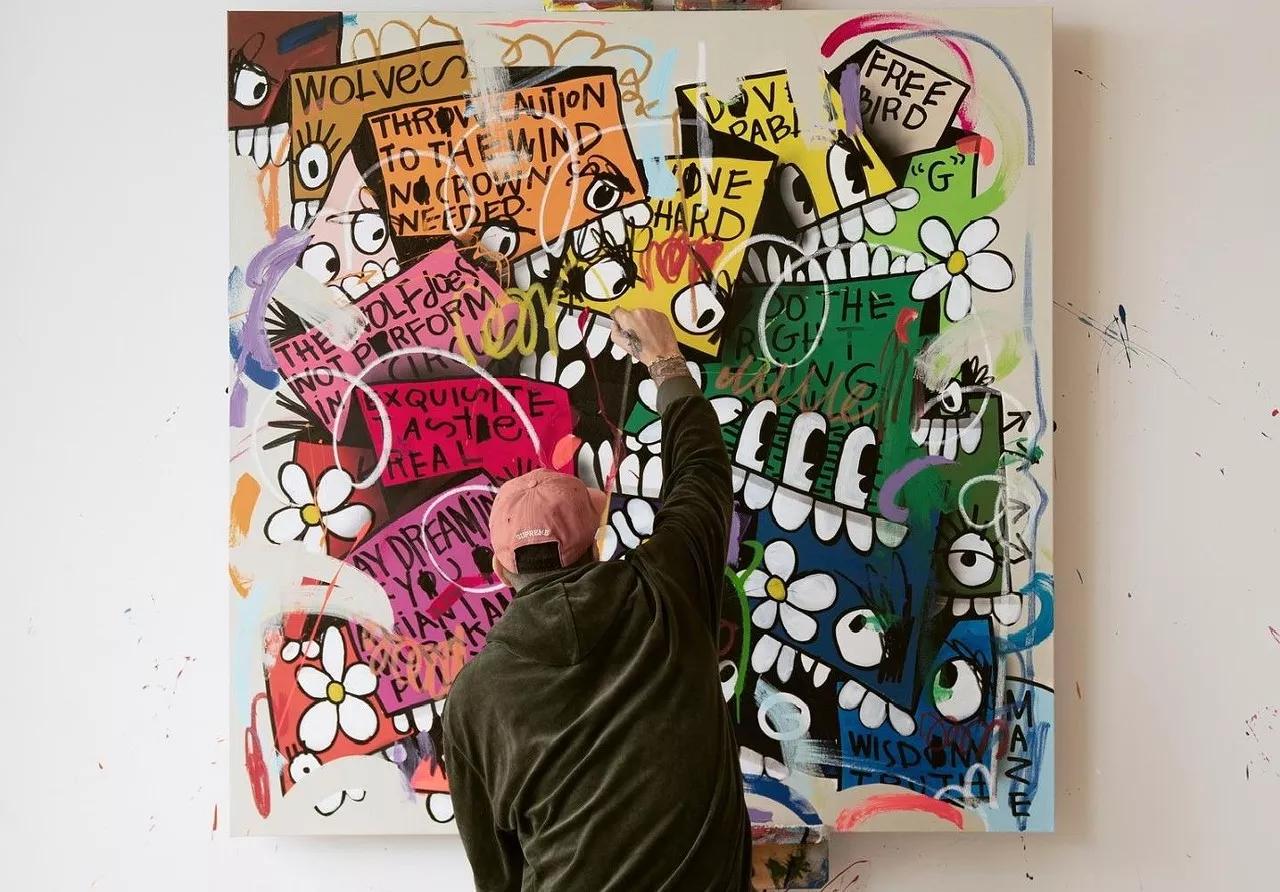 Artist Christopher "Flore" Florentino at his easel, creating one of his colorful street art-inspired works.