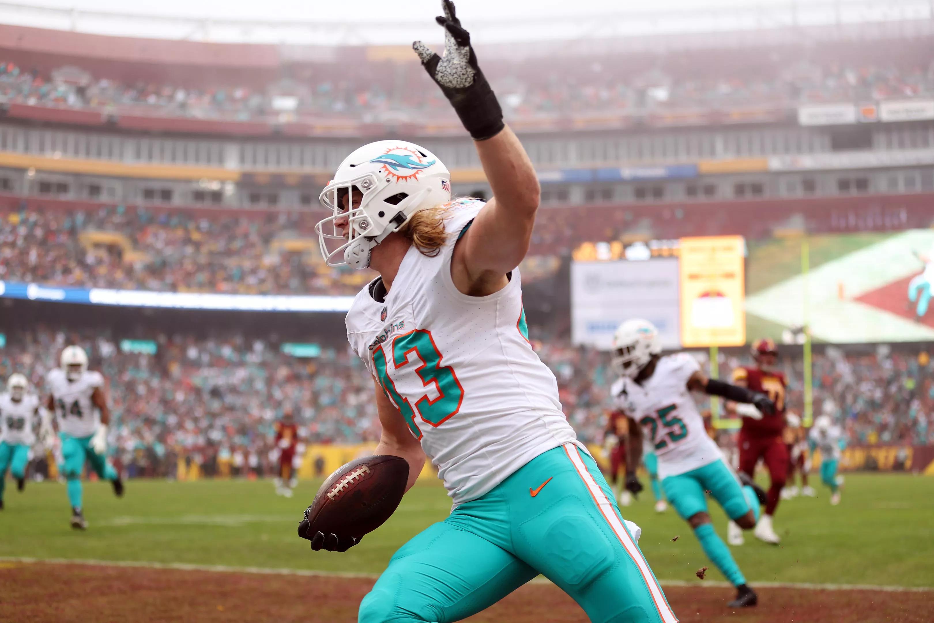 Dolphins linebacker Andrew Van Ginkel waves his hand in the air while celebrating a pick-6 against the Commanders.