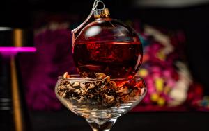 A holiday cocktail at Rosa Sky looks like a red Christmas ornament